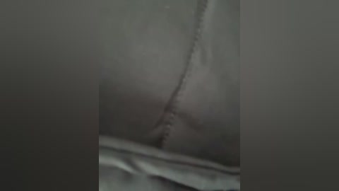 A close-up video of a person's bare buttocks, with a visible, linear scar running diagonally across the skin, creating a noticeable contrast. The background is indistinct, focusing solely on the scarred area.