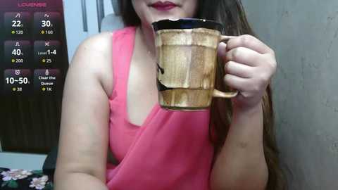 Video of a woman in a pink tank top holding a wooden mug with a straw, surrounded by a digital weather display showing 22\u00b0C, 10% humidity, and 10-50% chance of rain.