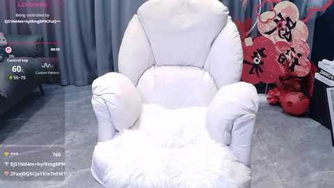 Video of a plush, white, fluffy armchair with a high backrest and large cushions, surrounded by red Chinese lanterns and grey curtains in a dimly lit room.