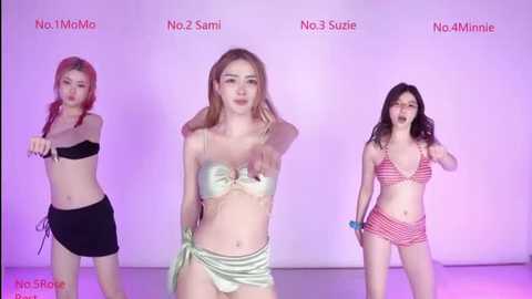 Video of three Asian women in bikinis, No. 2 Sammi in a metallic silver bikini, No. 3 Suzy in a red and white checkered bikini, and No. 1 Momoi in a black bikini, posing against a pink backdrop.