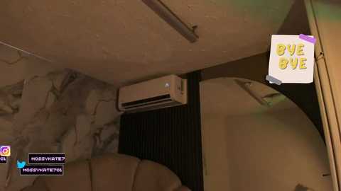 A dimly lit, indoor, first-person video game screenshot shows a beige, tiled wall, an air conditioner, and a \"GIVE UP\" sign with a red X, evoking a gloomy, abandoned room atmosphere.