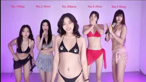 Video of four Asian women in bikinis, with one in a black bikini with paw prints, against a white background.