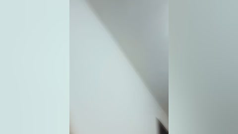 This is a video featuring abstract, overlapping white sheets creating a geometric, almost cubist-like pattern. The image has a minimalist, modern aesthetic with soft, diffuse lighting.