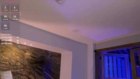 Video of a modern, dimly lit room with a marble wall, wooden-framed window, and a digital screen displaying a game interface.