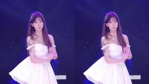 Video of an East Asian woman with long brown hair, wearing a white off-shoulder dress, standing on a stage with dark background, looking solemn.